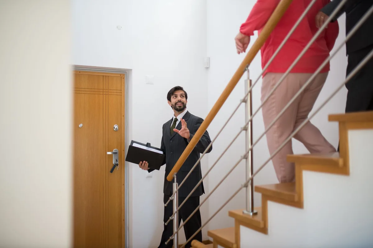 Mandataire immobilier indépendant faisant visiter une maison à un acheteur